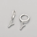 Detail of silver letter Y charm earrings with white zircons on a gray background - Silver / Y