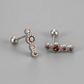 Macro shot of S925 silver stud earrings with four curved reddish-brown zircons and screw backs - Silver Base Red Zirconia