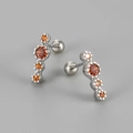 Close-up of silver screw-back earrings featuring four vertical round orange zircons - Platinum Orange Zirconia