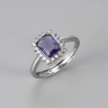 Macro detail of rectangle purple gemstone ring with sparkling white zircon halo accents - Silver/Purple