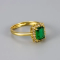 Detail view of emerald cut green zircon ring with gold plating and paved accents - Gold/Green