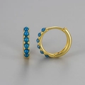 Detail of gold-plated hoop earrings featuring inlaid blue opal stones on a grey background - Medium / Gold-Blue