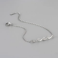 Detail view of wavy silver bracelet featuring micro-pave stones and S925 sterling silver tag - Platinum Color White Zirconia