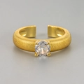 Detailed macro view of gold textured ring band with large round cubic zirconia stone - Adjustable Open / Brushed Single Stone Ring / Gold