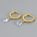 Detailed close-up of golden huggie hoops with zircon accents and pear-shaped drop charms - Gold White Zirconia