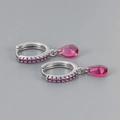 Macro detail of S925 sterling silver stamp and purple teardrop zircon earrings - Silver Base Red Zirconia