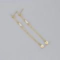 Minimalist gold chain tassel earrings with rectangular cubic zirconia on a grey background - Copper / Gold White Zirconia