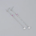 Detail of silver chain tassel earrings with pink cubic zirconia stones on grey background - Copper / Platinum Plated Rose Red Zirconia