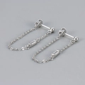 Macro detail of silver tassel earrings with delicate chains and rectangular cubic zirconia - Copper / Platinum White Zirconia