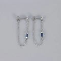Macro shot of silver tassel chain earrings featuring a rectangular blue zircon stone - Copper / Platinum Gold Dark Blue Zirconia