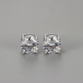 Detailed view of round-cut cubic zirconia studs with a classic four-prong silver setting - White Gold / 8mm