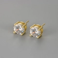 Detail of four-prong gold earring with sparkling round clear cubic zirconia stone - Gold / 8mm