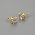 Macro shot of gold-plated round cubic zirconia studs with a classic four-claw setting - Gold / 7mm