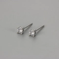 Macro shot of silver four-prong stud earrings with round-cut sparkling cubic zirconia - White Gold / 3mm