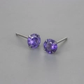 Macro side view of round purple zircon stud earrings with classic four-prong silver setting - 6mm / Purple