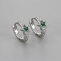 Detailed macro view of silver star hoop earrings with green enamel and white zircon stones - Copper / Silver Green
