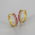 Close-up of gold-plated hoop earrings with rectangular pink cubic zirconia stones - Gold/Red Zirconia
