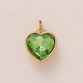 Detailed macro view of heart-shaped gold pendant with a large green gemstone and tiny diamonds - Exquisite Green Heart Style