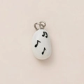 Macro detail of white pebble music pendant with black musical notes and silver metal bail - No.12 Musical Note Pendant