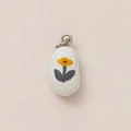 Detail of organic pebble pendant in white ceramic with yellow floral pattern and gold loop - Yellow Flower Pendant