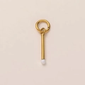 Macro detail of a 18k gold-plated bar pendant with a small white pearl bead for DIY jewelry - Matchstick Pendant / Gold