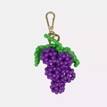 Detailed view of handmade purple beaded grape charm with gold-tone carabiner clip - Grapes