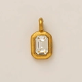 Macro detail of a gold-plated rectangular charm featuring a baguette-cut clear crystal stone - White Zirconia Pendant