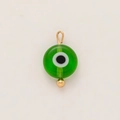 Macro shot of 18K gold plated stainless steel evil eye pendant with green resin - Green Eyes