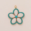 Detailed macro view of the gold flower pendant with white pearly petals and blue beads - Blue Edge Flower Style
