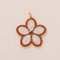 Detailed close-up of a flower pendant with white enamel petals and orange crystal inlay - Red Edge Flower Style