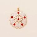 Macro shot of vintage style star-pattern pendant with red beads and white enamel - Red Zircon Flower Style