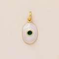 Detail of gold-plated oval pendant with white enamel inlay and green zircon gemstone - May Birthstone Pendant