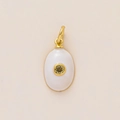 Detailed view of an oval gold pendant with white enamel inlay and yellow zircon stone - August Birthstone Pendant