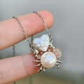 Silver spider pendant necklace featuring heart-shaped pearl and blue moonstone detail - Silver Heart Crab (Natural Pearl)