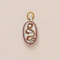 Macro detail of oval pendant with orange snake art and gold ring on beige background - No.4 Oval Snake
