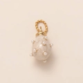 Macro detail of egg-shaped cream enamel pendant with pearls and golden braided ring - Pearl Pendant