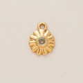 Detailed macro view of an 18K gold plated flower pendant with a clear center gemstone - Rhinestone Inlaid Round Pendant