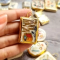 Macro detail of rectangle floral enamel pendant with 18K gold plated frame and bail - House Ceramic-Look Pendant