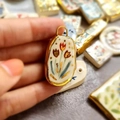 Detailed macro view of an oval tulip ceramic pendant with elegant gold vacuum plating trim - Tulip Ceramic-Look Pendant