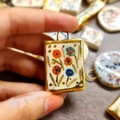 Close-up of a floral print rectangular pendant with 18K gold plated edges for DIY jewelry - Multi-Flower Ceramic-Look Pendant