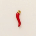 Macro shot of a red Italian horn corno pendant with a golden 18K vacuum plated ring - Red Chili