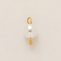 Detailed close-up of a high-luster white pearl pendant with 18K gold plated metal ring - Beaded Pearl