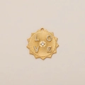Macro shot of gold sunburst pendant with LOVE inscription and centered cubic zirconia - Initial Pendant