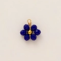 Macro detail of a 18k gold plated floral pendant with deep blue faceted beads - Blue Beaded Flower Pendant