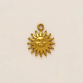Macro view of vintage gold sunburst face pendant with bohemian style facial relief - Vintage Gold Sun God Face Pendant