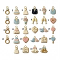 Flat lay of 23 gold 18K plated wedding charms with enamel details for DIY jewelry making - No.1 Blue Ring Pendant