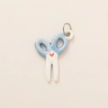 Detailed view of scissor-shaped ceramic pendant with blue handles and red heart - Scissors Pendant