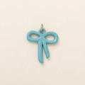 Macro shot of sky blue bow charm with glossy enamel finish and silver metal ring - Bowknot Pendant