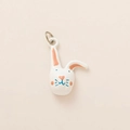 Detailed close-up of a white ceramic rabbit pendant with pink ears and a metal ring loop - Little Rabbit Pendant