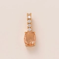 Macro view of rose gold pendant featuring an oval orange gemstone and clear zircons - Orange Oval Gemstone Style (6)